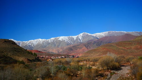 Scenic view of mountains against clear blue sky