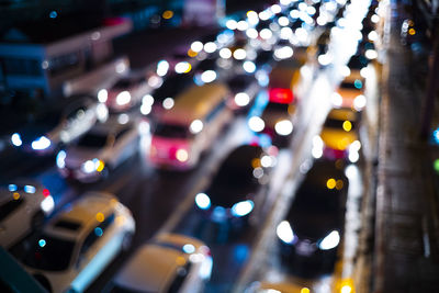 Defocused image of traffic on city street at night