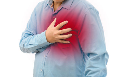 Midsection of woman standing against white background