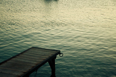 Empty bench in water