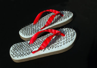 High angle view of red shoes against black background