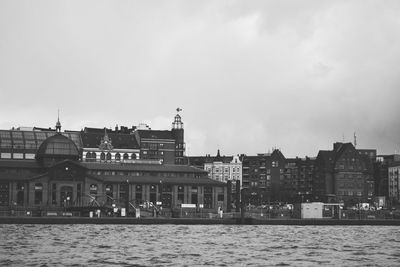 Buildings in city against cloudy sky