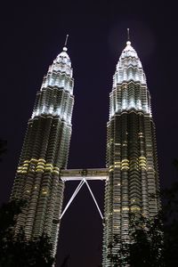 Low angle view of illuminated buildings against sky at night