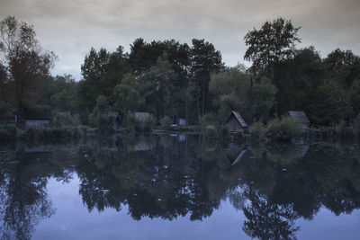 Reflection of trees in lake against sky