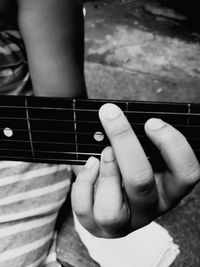 Close-up of man playing guitar