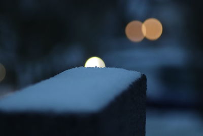 Close-up of illuminated lights against sky