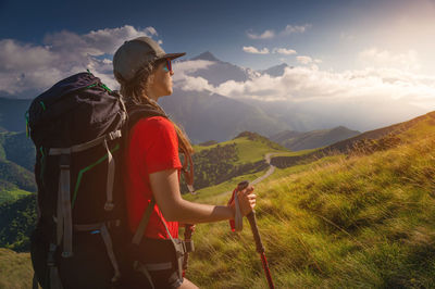 Woman tourist young caucasian walking uphill on a sunny day under sunlight. nice view of the