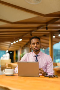 Portrait of man working on table