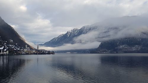 Scenic view of lake by mountains against sky