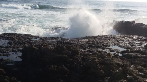 Waves rushing towards rocky shore