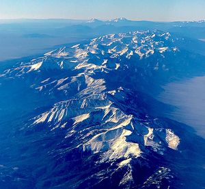 Aerial view of sea and mountains against sky