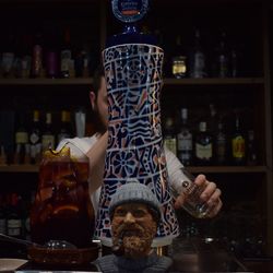 Man drinking glass with bottles