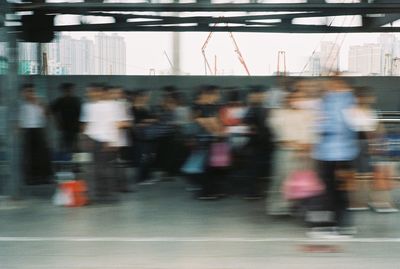 Blurred motion of people walking on street in city