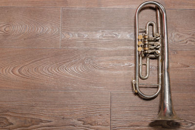 Close-up of door knocker on wooden floor