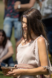 Midsection of woman looking at camera