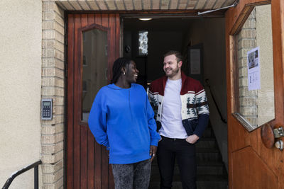 Couple standing at front door