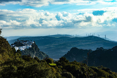 Scenic view of sea and mountains against sky