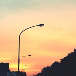 Low angle view of silhouette trees against sky at sunset