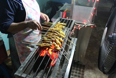 Man working on barbecue grill