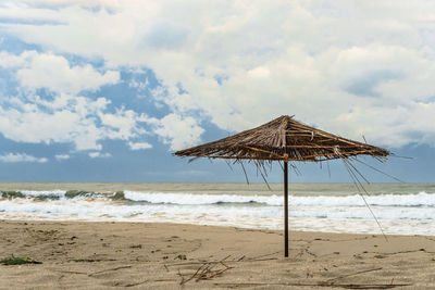 Lifeguard hut on beach against sky