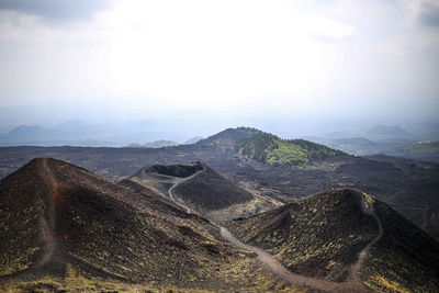 High angle view of land and mountains against sky