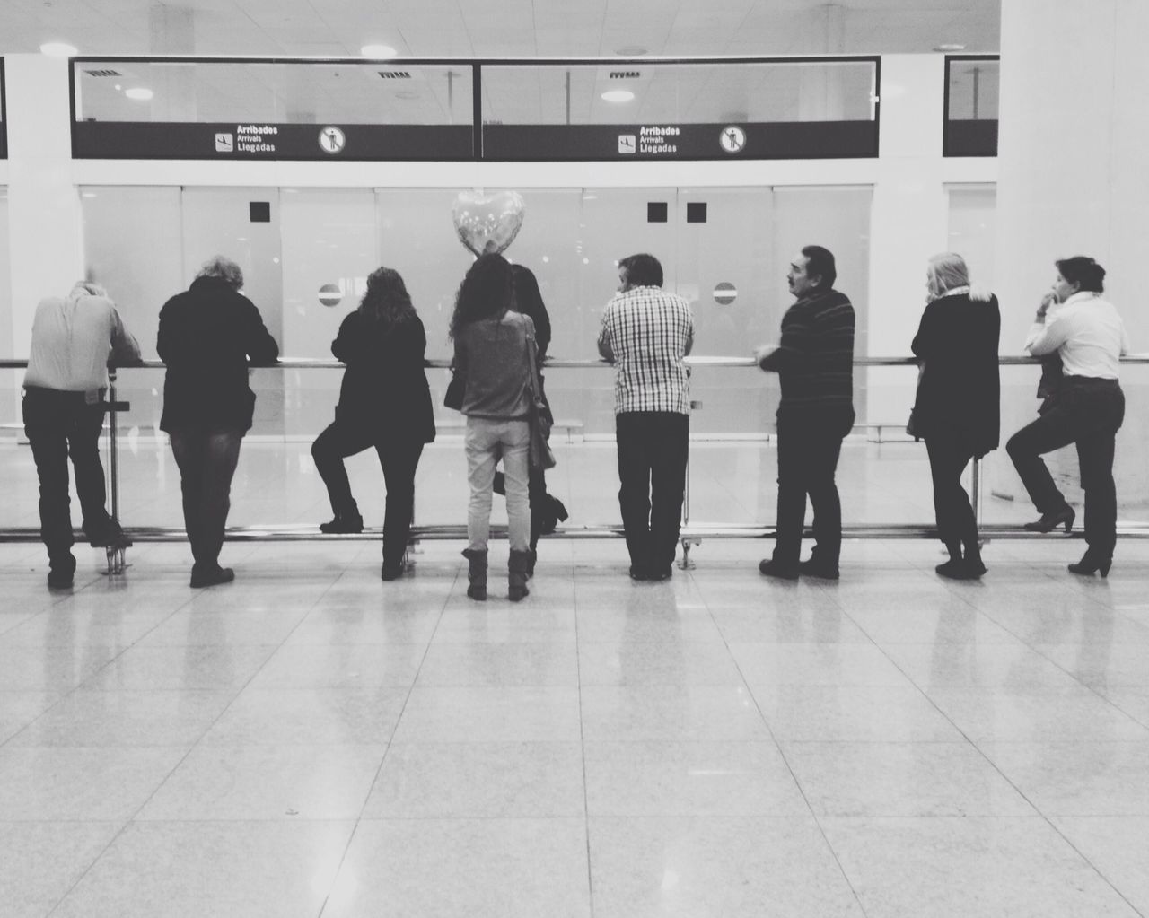 indoors, men, person, lifestyles, large group of people, walking, railroad station, tiled floor, flooring, medium group of people, public transportation, architecture, city life, railroad station platform, full length, leisure activity, subway station, built structure, reflection