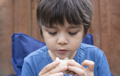 Close-up of boy eating food