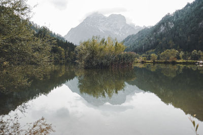 Reflection of trees in lake against sky