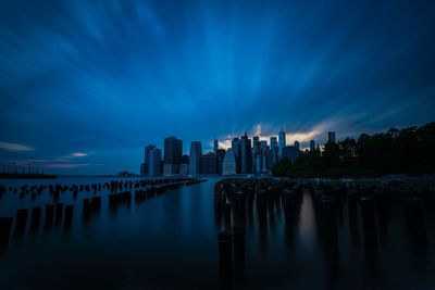 Panoramic view of bay in city against sky at dusk