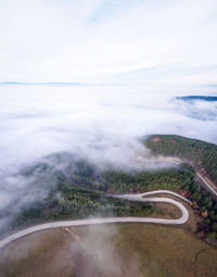 Scenic view of road by land against sky