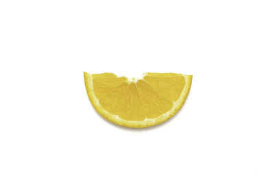 Close-up of lemon slice over white background