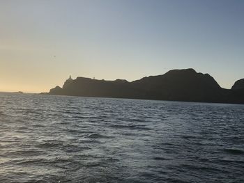 Scenic view of sea against clear sky during sunset