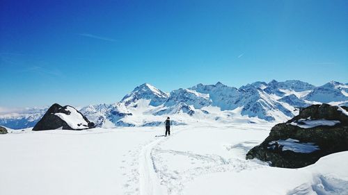 Scenic view of snow covered mountains against clear sky