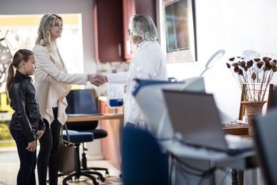 Doctor greeting patients in medical practice