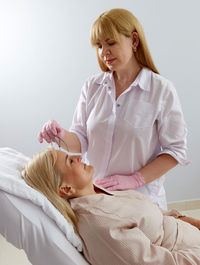 Doctor examining patient at home