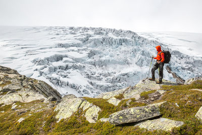 Full length of woman standing on cliff