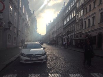 Vehicles on road along buildings