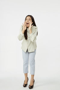 Portrait of a smiling young woman against white background