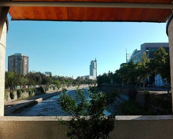 City by bridge against clear sky