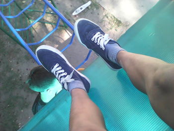 Low section of boy standing on outdoor play equipment