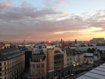 High angle view of buildings in city during sunset