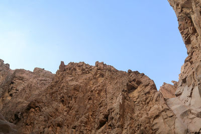 Low angle view of rock formations against clear sky