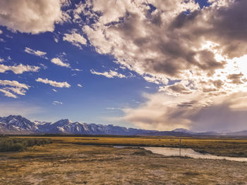 Arid plains against sierra nevada mountains and clear blue sky in the owens river valley