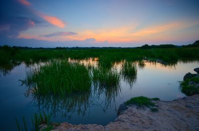 Scenic view of lake against sky during sunset