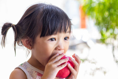 Close-up portrait of cute girl drinking ice cream