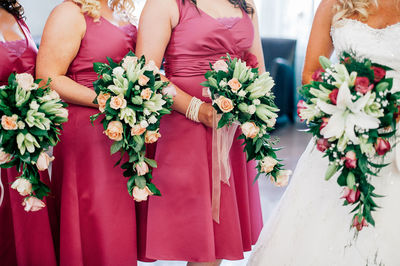 Bride and bridesmaids holding flower bouquets