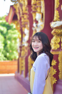 Portrait of young woman standing in market