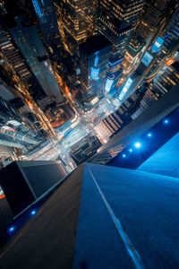 High angle view of illuminated buildings in city at night