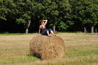 Woman relaxing on grassy field