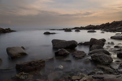 Scenic view of sea against cloudy sky
